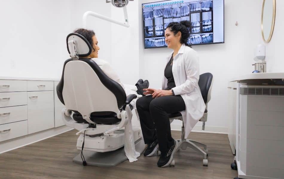 Dr. Maria Elena Rodriguez sitting and talking to a patient